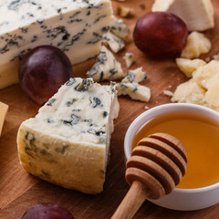 set of different cheeses on a wooden rustic background