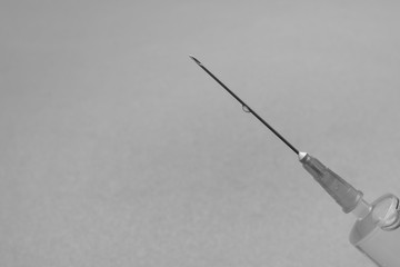 Needle of a syringe close-up on a black and white background