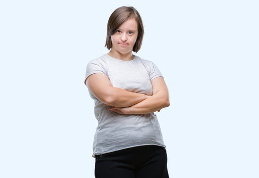 Young adult woman with down syndrome over isolated background happy face smiling with crossed arms looking at the camera. Positive person.