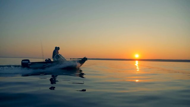Slow motion floating process of two fishermen during sunrise