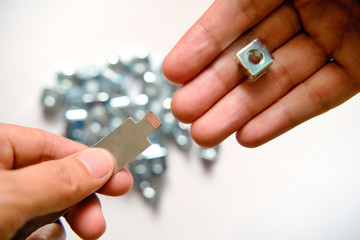 Fototapeta premium Rack mounting equipment Cage nuts with Rack Studs on the hand of the engineer.