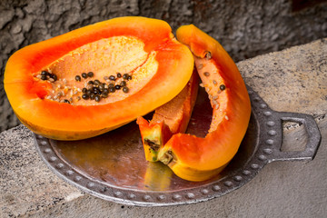 Juicy papaya on a metal tray