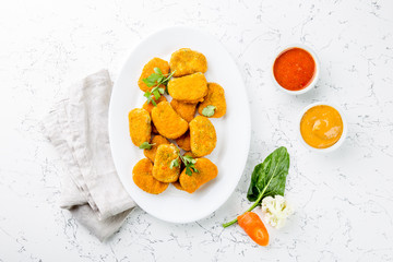 Healthy vegetarian nuggets with carrots, cauliflower and spinach. Vegetable nuggets. Vegan food. Top view, white background