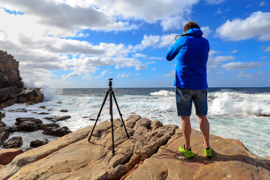 Photographer Person at Cape Point South Africa Taking Photos of Ocean Waves on Rock