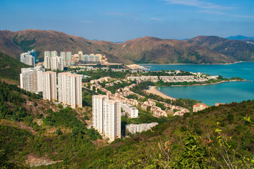 Fototapeta premium Discovery Bay, Hong Kong with Buidlings and Harbour seen from Hills on Lantau Island