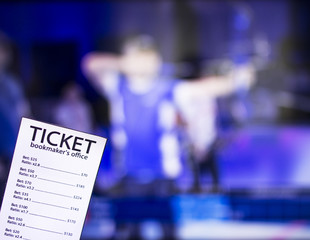 Fototapeta premium Bookmaker ticket on the background of TV on which show sports archery, sports betting, bookmaker, archery