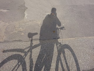 Creative Cycle Bicycle Cyclist Shadow Silhouette On The Asphalt Road Surface 