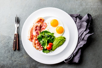 Ketogenic diet breakfast. fried egg, bacon and avocado, spinach and bulletproof coffee. Low carb high fat breakfast