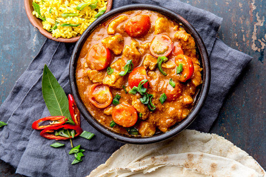 INDIAN FOOD. ROGAN JOSH curry sauce. Pork rogan josh with rice and naan bread