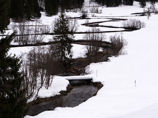 A winding river in a white winter landscape 