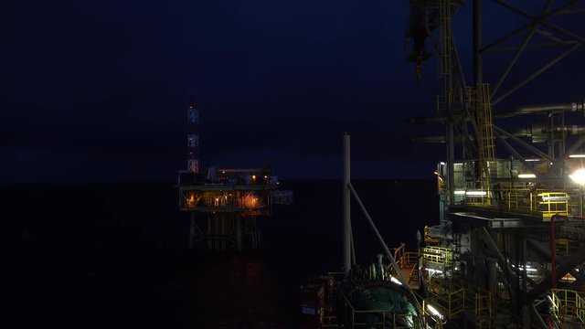 Night scene of the oil field drilling rig and offshore platform