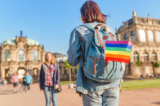 Two girls travelers having fun in Dresden with rainbow flag symbol. Free love relationship concept