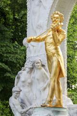 The golden statue of the great musician Johann Strauss in the city park, Vienna, Austria (built in 1921)