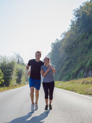 Fototapeta premium young couple jogging along a country road