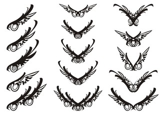 Abstract eagle eye and tribal wings symbols. Tribal set of ornate eagle wings and a laconic eye in the form of an eagle, similar to an emblem on a white background for your design