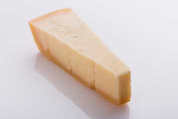 A fragrant parmesan piece on a white acrylic background
