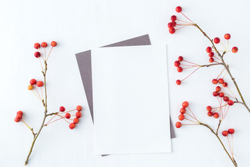 Mockup blank paper card and branch with small red apples