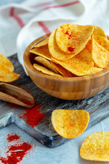 Bowl of paprika potato chips.