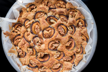 Top view on homemade plum cake with english walnuts
