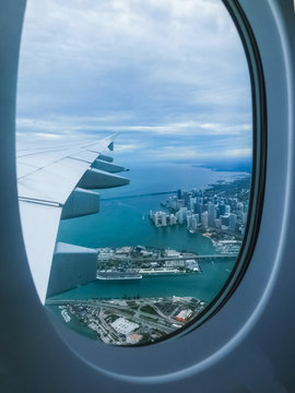 Miami Beach skyline from airplane porthole at day