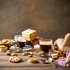 Dutch holiday Sinterklaas, festive breakfast with coffee, kruidnoten, traditional sweets and presents. st. Nicolas day concept. Copy space.