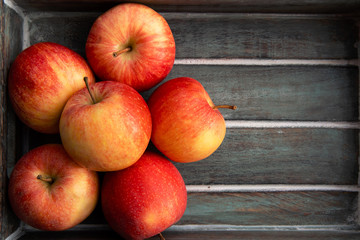 Gala apples in an wooden box