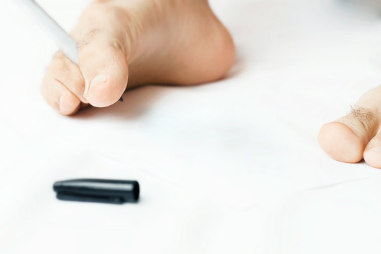 Male writing using foot