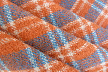 woolen checkered fabric close-up orange blue drape