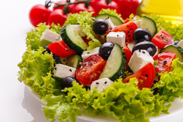 Greek salad on a white acrylic background