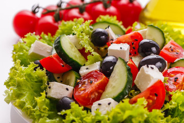 Greek salad on a white acrylic background