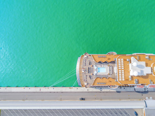 Aerial View by Drone of Cruise ship at harbour. Top view of beautiful large white liner in yacht...