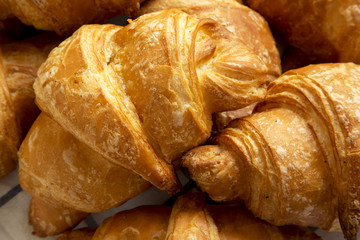 Fresh croissants on cloth, closeup.