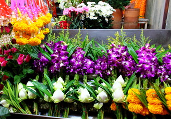 Bouquets of yellow marigolds, purple orchids and white lotuses for Buddha worship in Thailand. 