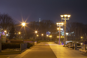 Fototapeta premium Lights of night city. Cityscape of night Minsk, Belarus. Embankment in Minsk. City landscape in evening.