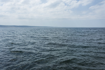Naklejka na ściany i meble Sea view with waves. Exact horizontal horizon. Blue sea level.