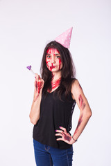 Halloween zombie bloody brunette woman celebrate holidays with whistle on white background