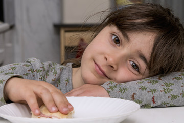 Young girl eating a sandwich