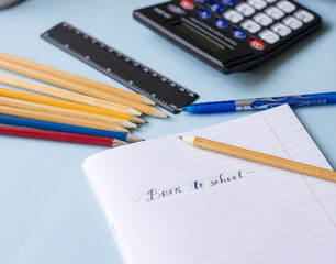 Notepad, pencils, calculator  on the table flat lay