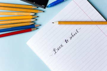 Notepad, pencils, calculator  on the table flat lay
