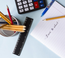 Notepad, pencils, calculator  on the table flat lay