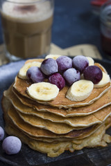 Pancakes with bananas and cherries on the top