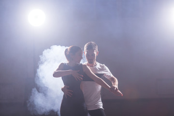 Active happy adults dancing bachata together in dance class