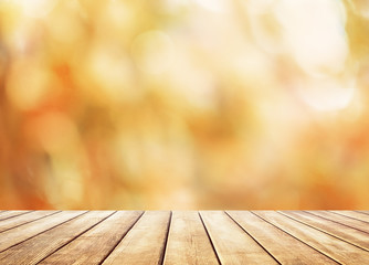 Naklejka na ściany i meble Wooden table top on blur abstract autumn background