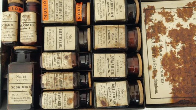 Opening an antique medicine set from early 20th century.  Many are now considered poisons. Some early synthetic analgesics, Aspirin, sodium salicylate and Antifebrin (Acetanilide) in top row. 