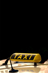 Close-up of German Taxi Cab Sign Against A Black Background