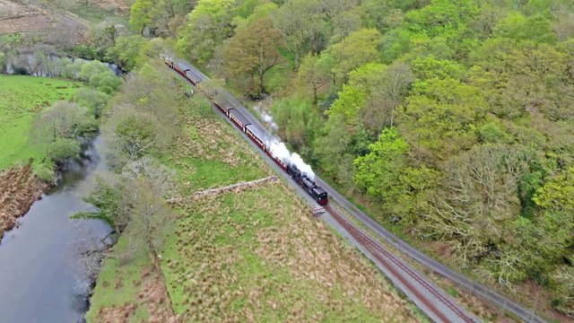 Aerial view of steam train driving through the Snowdonia National Park in Wales - United Kingdom