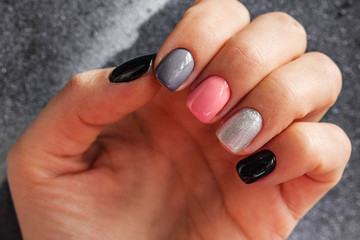 The manicured nails on the grey background