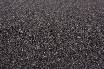 Сlose up of black sandpaper sheet texture, background or backdrop