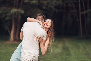 Fototapeta premium Beautiful Young Couple Have Fun at Sunset Outside of City