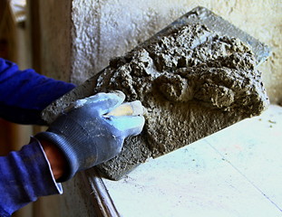 builder applying mortar cement to the walls stock photo